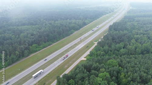 Truck on empty road through scenic countryside photo