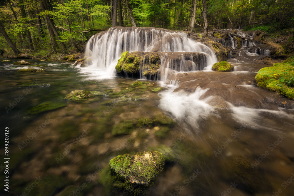 Obraz premium Real image no AI waterfall in the forest beautiful river cascading, trees in the background