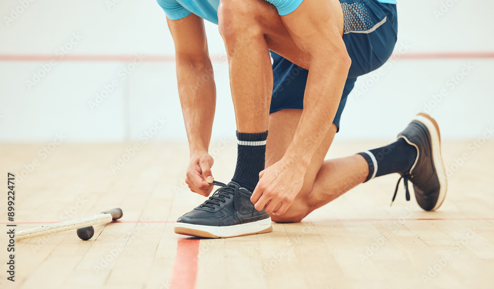 Man, hands and tying shoes for exercise, wellness and workout practice for competition on court. Squash, male athlete and tie sneakers on floor for fitness training, health and challenge in arena Man, hands and tying shoes for exercise, wellness and workout practice for competition on court. Squash, male athlete and tie sneakers on floor for fitness training, health and challenge in arena