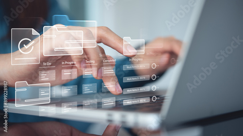 Business developer using Kanban board framework on laptop computer. Agile software development lean project management tool, project management, business development concept photo