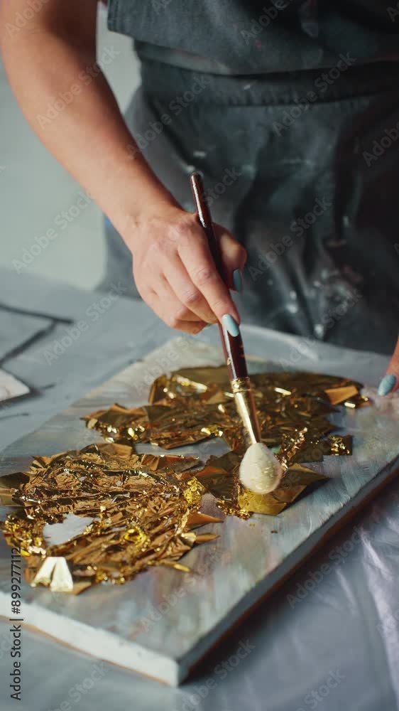 Creating Abstract Gold Leaf Artwork in a Modern Art Studio Creating Abstract Gold Leaf Artwork in a Modern Art Studio