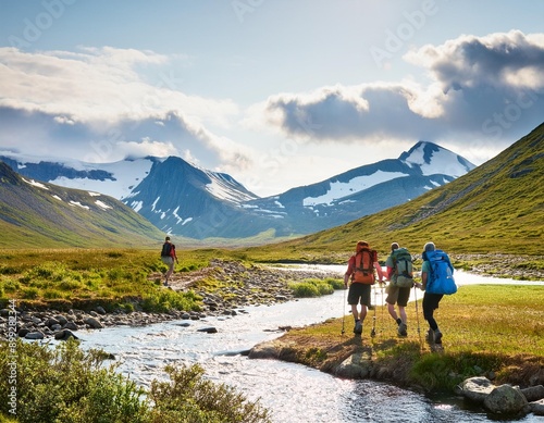close up of Group of traveling backpacker hiking walk across the little river in Scandinavia in fjords of Norway