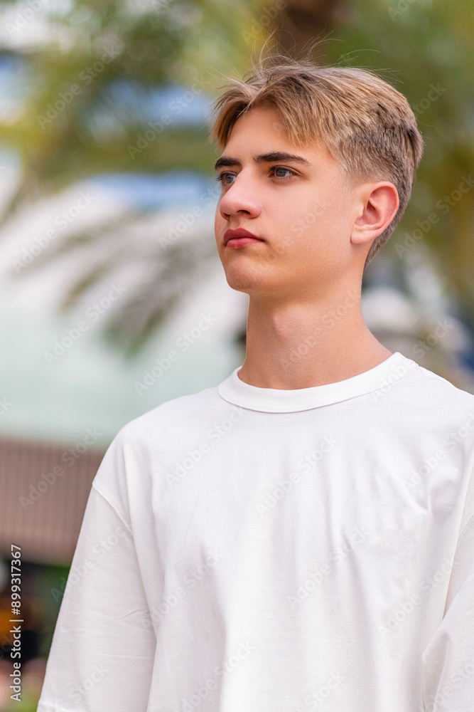 Portrait of a dreamy young man on a summer background. vertical Portrait of a dreamy young man on a summer background. vertical
