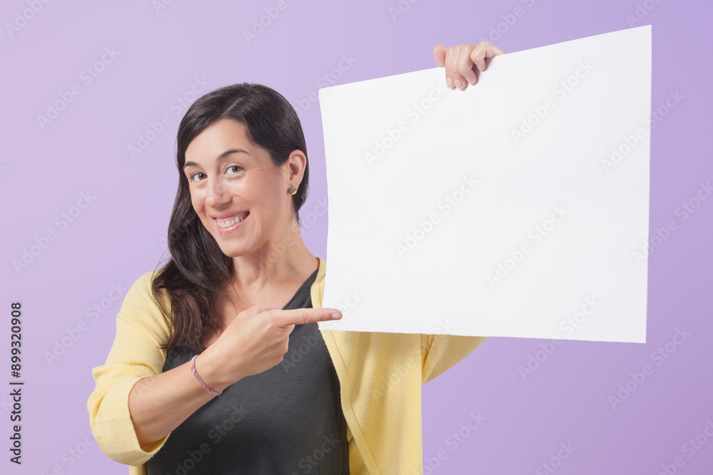Portrait of woman laughing and pointing to a blank white banner on purple background. Portrait of woman laughing and pointing to a blank white banner on purple background.