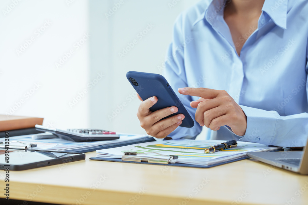 A young Asian woman sits at a desk, attentively analyzing graphs and financial data. She is focused and determined, highlighting her expertise in financial analysis and business strategy. A young Asian woman sits at a desk, attentively analyzing graphs and financial data. She is focused and determined, highlighting her expertise in financial analysis and business strategy.