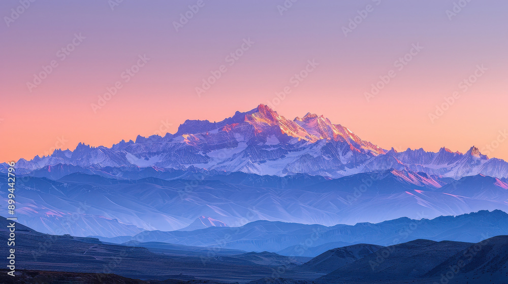 A panoramic view of a mountain range during sunrise with a clear sky. A panoramic view of a mountain range during sunrise with a clear sky.