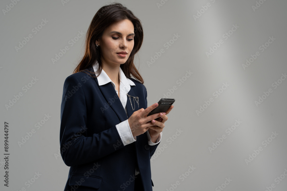 Television presenter in blazer and formal wear checking phone Television presenter in blazer and formal wear checking phone
