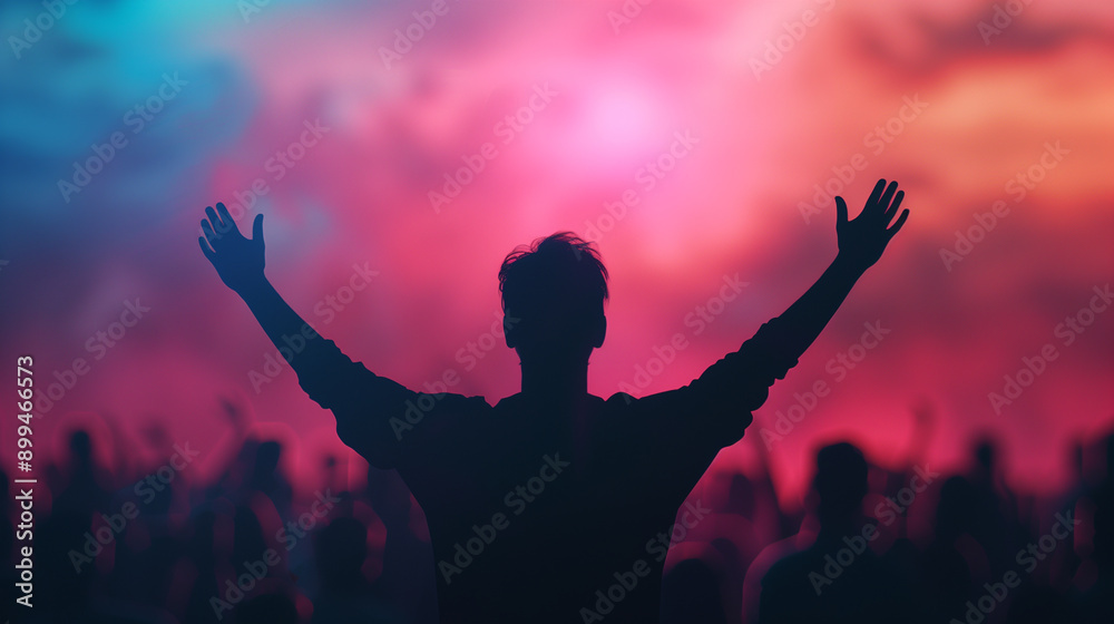 Silhouette of a person at a concert, arms raised in the air, against a vibrant background of pink lights, creating a celebratory and energetic mood. Silhouette of a person at a concert, arms raised in the air, against a vibrant background of pink lights, creating a celebratory and energetic mood.