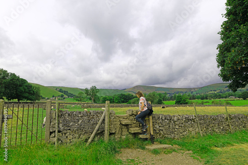 Obraz na plátně Stepping over the wall stile, in Castleton.