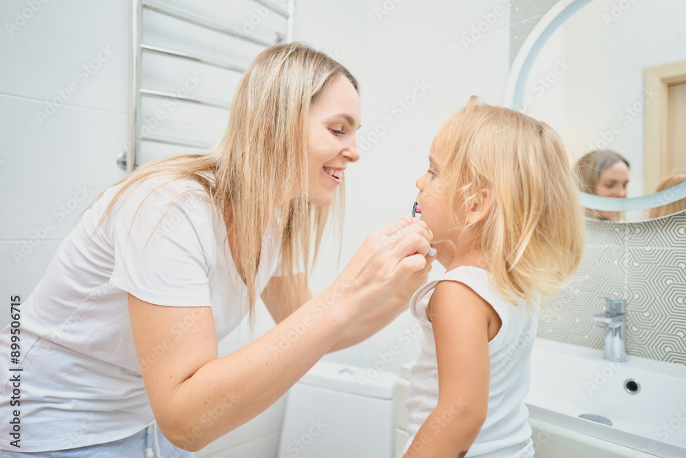 Woman and child brushing each other's teeth Woman and child brushing each other's teeth
