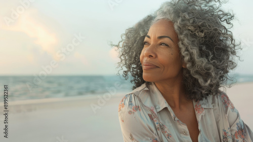 Thoughtful Woman Enjoying a Tranquil Moment by the Ocean at Sunset