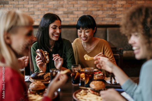 Принти на полотні Young happy people having lunch together