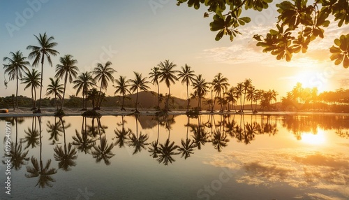 Sunset Reflections Palm trees mirrored in the still waters of a tropical lagoon at sunset.