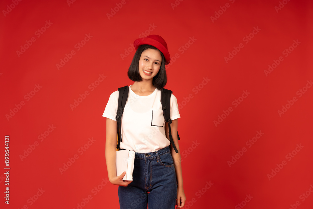 Each day at university is filled with new opportunities for growth, where a young female student cultivates a deep respect for education and its role in shaping her future in a red background studio. Each day at university is filled with new opportunities for growth, where a young female student cultivates a deep respect for education and its role in shaping her future in a red background studio.