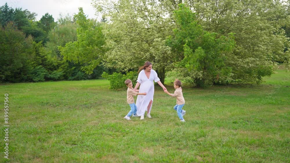 Young Family Picnic Pregnant Mom white dress and Twins.Happy pregnant mom smiles and walks in the park with twins. Green grass and trees. Happy family enjoying summer holidays.
Happy Mom Smile. Young Family Picnic Pregnant Mom white dress and Twins.Happy pregnant mom smiles and walks in the park with twins. Green grass and trees. Happy family enjoying summer holidays.
Happy Mom Smile.
