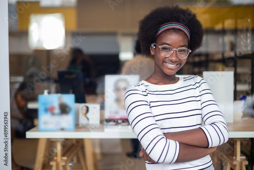 Portrait happy young woman African American afro hair smile wear spectacles crossed arm standing at in optical shop. modern ophthalmologist concept.