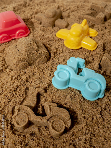 Still life of the molds of a children's set on the sand in sunny weather