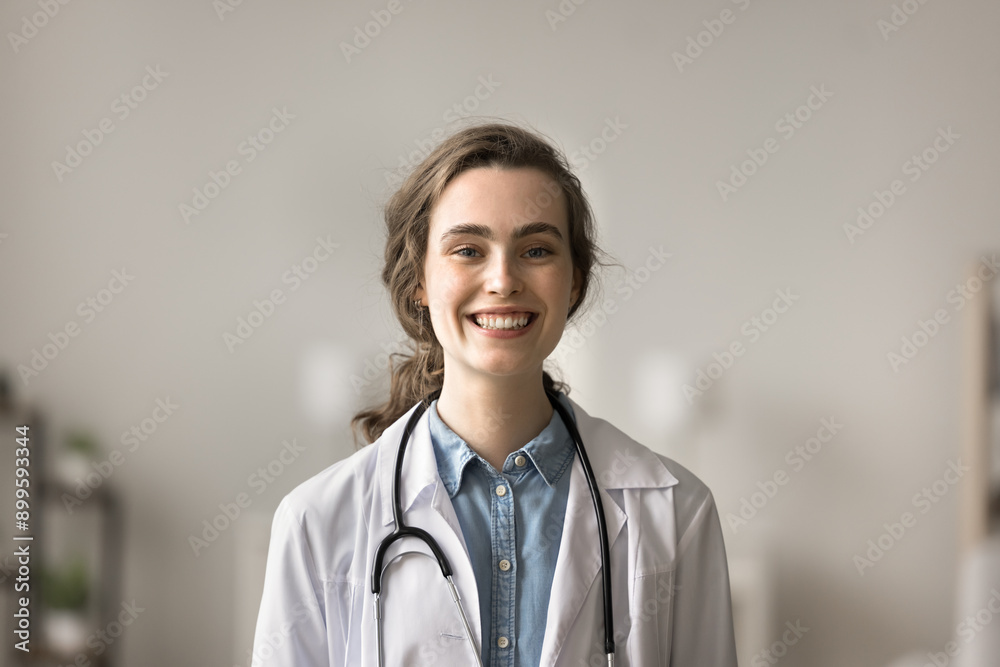 Head shot portrait of young woman medical graduate, pediatrist in white coat posing at workplace clinic office, smile, look at camera feel happy. Internship, healthcare, medical worker profile picture Head shot portrait of young woman medical graduate, pediatrist in white coat posing at workplace clinic office, smile, look at camera feel happy. Internship, healthcare, medical worker profile picture