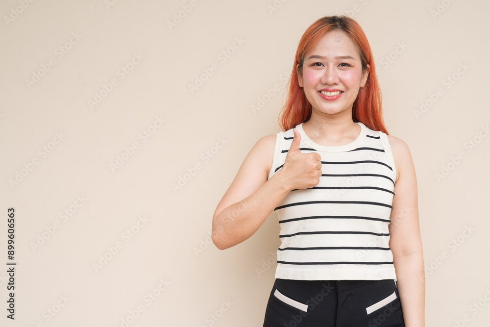 Portrait of Beautiful Asian Woman Giving Thumbs Up Against Plain Background Portrait of Beautiful Asian Woman Giving Thumbs Up Against Plain Background