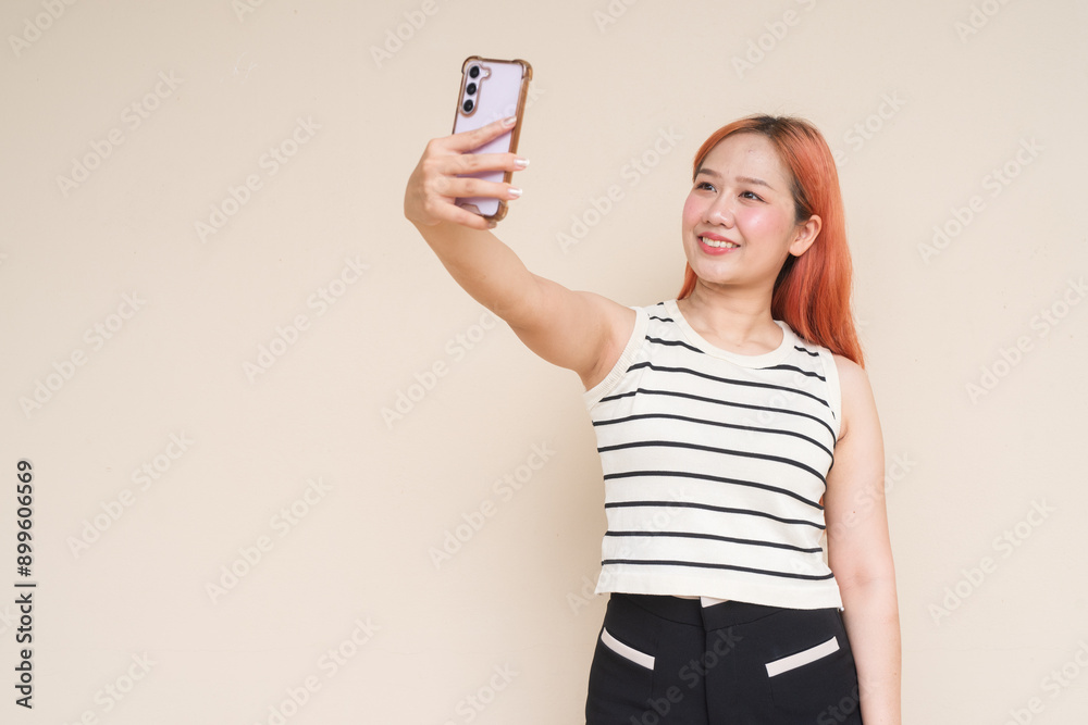 Portrait of Beautiful Asian Woman Using Phone Taking Selfie Against Plain Background Portrait of Beautiful Asian Woman Using Phone Taking Selfie Against Plain Background