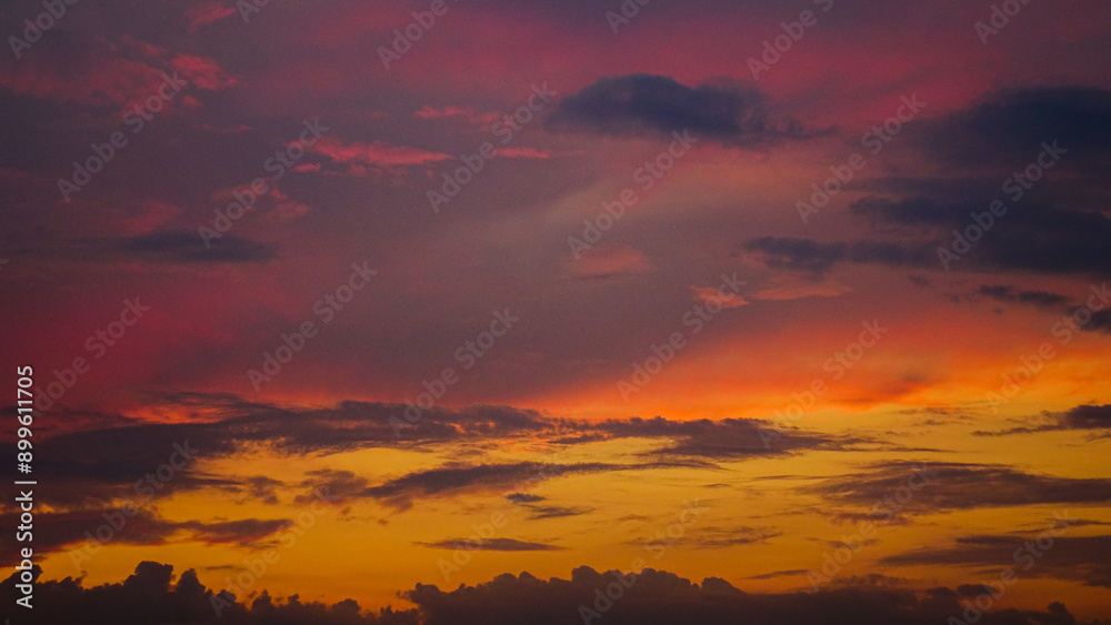 Fototapeta premium Bright yellow red sky and clouds at sunset, background