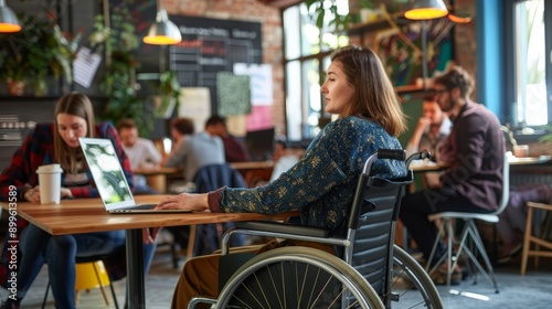 Woman in a wheelchair working in a trendy cafe, surrounded by people. Showcasing accessibility and inclusion in public spaces.