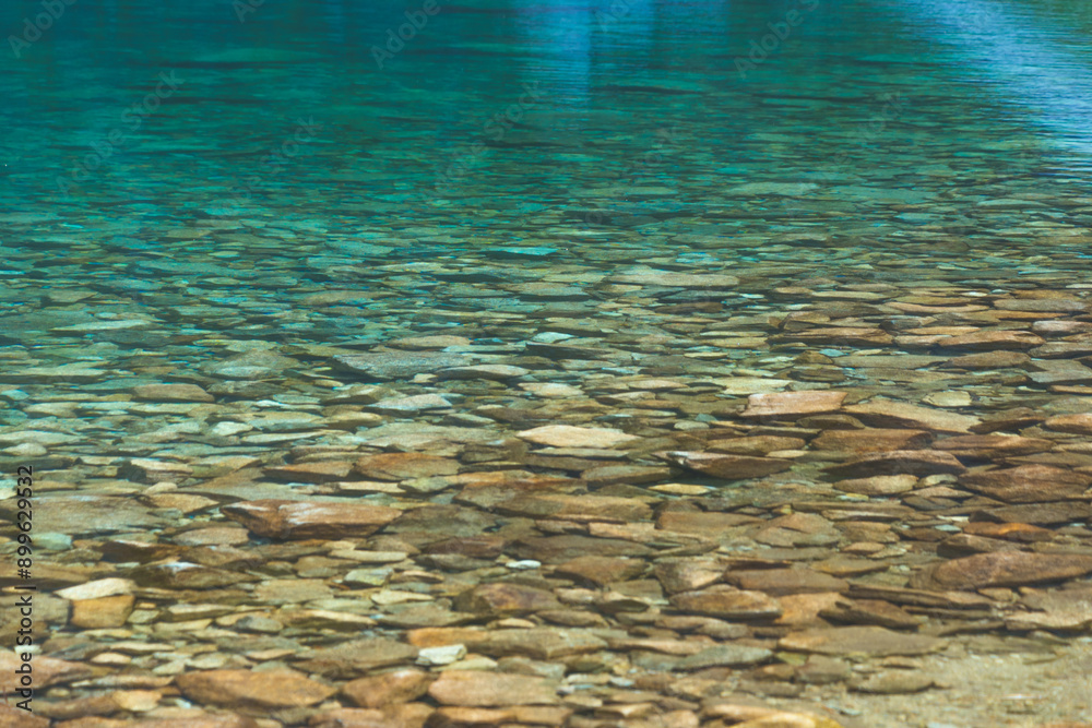 Fototapeta premium Transparent clean blue water in a mountain lake. Water background. Black Lake below Mount Rysy, Tatra Mountains