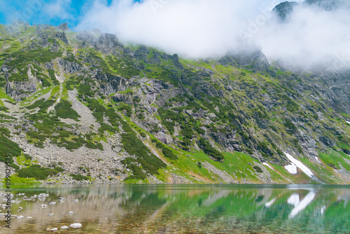 Mountain lake with blue water. Beautiful mountain landscape in summer. Black Lake below Mount Rysy. Tatras