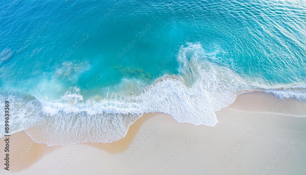 Obraz premium Beautiful tropical summer beach, top view of white sand and blue sea waves, nature background, vacation in paradise concept for tourism, vivid colorful.
