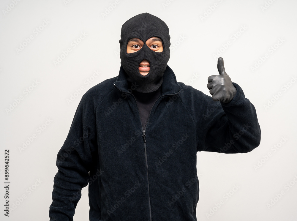 Thief in uniform black jacket various pose on isolated background. The Robber terrorism criminal escapes with balaclava and crowbar entering a house for stealing Housebreak Thief in uniform black jacket various pose on isolated background. The Robber terrorism criminal escapes with balaclava and crowbar entering a house for stealing Housebreak