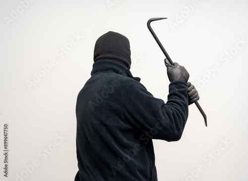 Thief in uniform black jacket various pose on isolated background. The Robber terrorism criminal escapes with balaclava and crowbar entering a house for stealing Housebreak