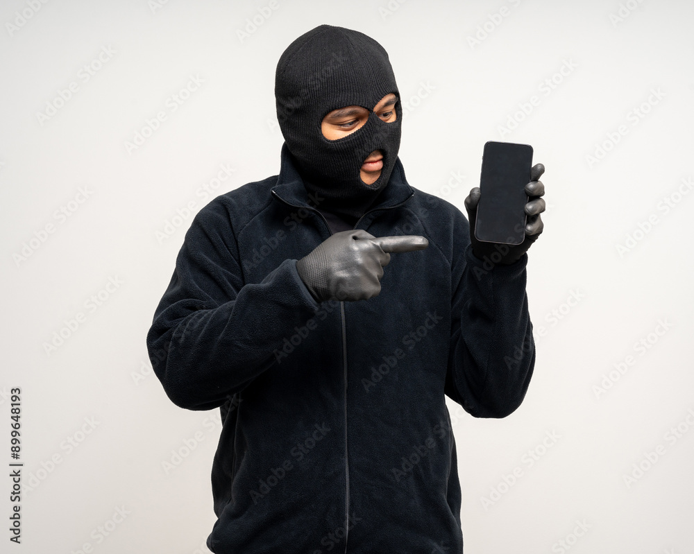 Thief in uniform black jacket various pose on isolated background. The Robber terrorism criminal escapes with balaclava and crowbar entering a house for stealing Housebreak Thief in uniform black jacket various pose on isolated background. The Robber terrorism criminal escapes with balaclava and crowbar entering a house for stealing Housebreak