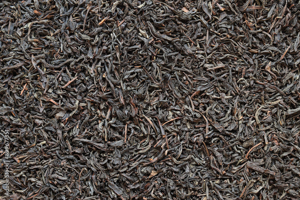 Long black tea, texture. Top view of dried tea leaves. Tea composition. Ingredients for a hot drink, close-up. Background Long black tea, texture. Top view of dried tea leaves. Tea composition. Ingredients for a hot drink, close-up. Background