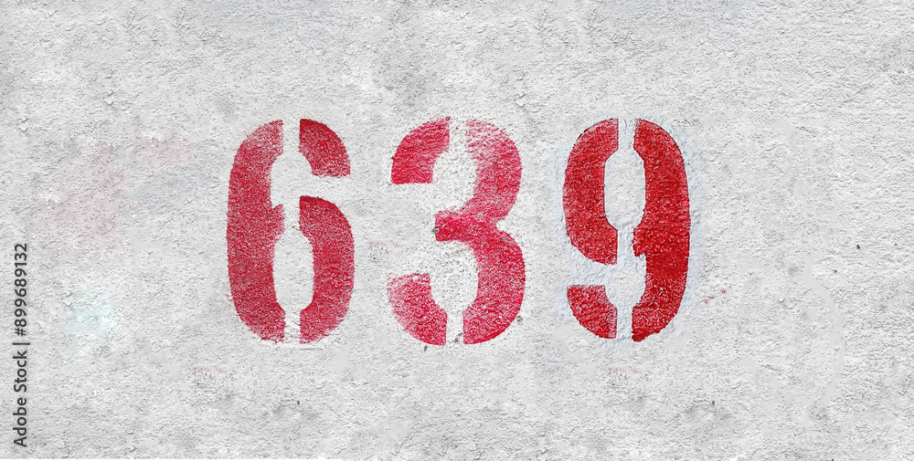 Red Number 639 on the white wall. Spray paint. Red Number 639 on the white wall. Spray paint.
