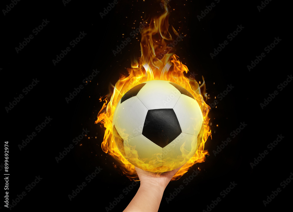 Naklejka premium Soccer ball in hand with burning flames.