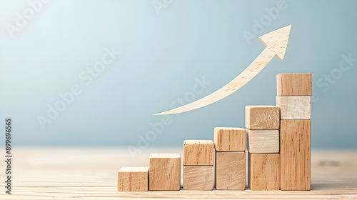 growth and progress through ascending wooden blocks and a curved arrow pointing upward