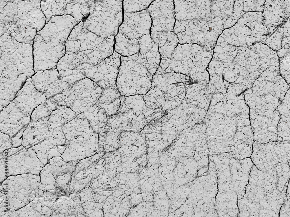 Dry cracked earth surface revealing patterns of drought conditions in rural landscape