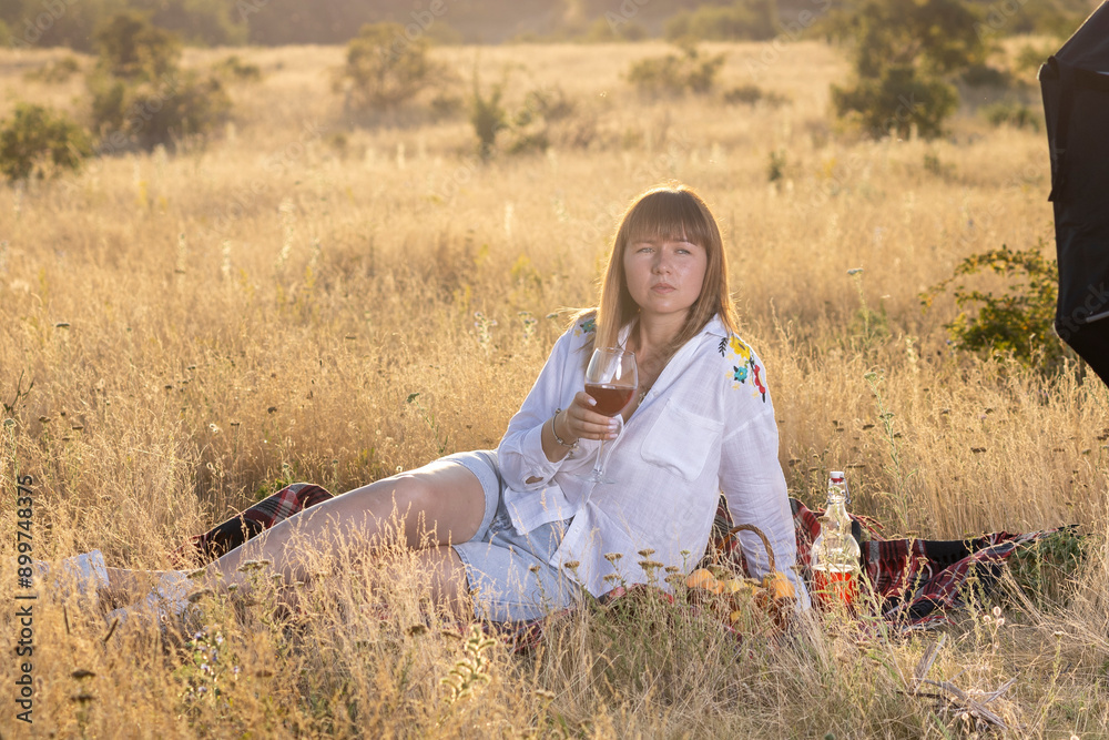 © Олег Мальшаков - Beautiful young girl with a glass of wine on a picnic