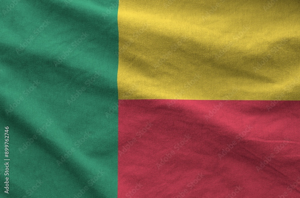 Benin flag depicted on folded wavy fabric of old cloth close up Benin flag depicted on folded wavy fabric of old cloth close up