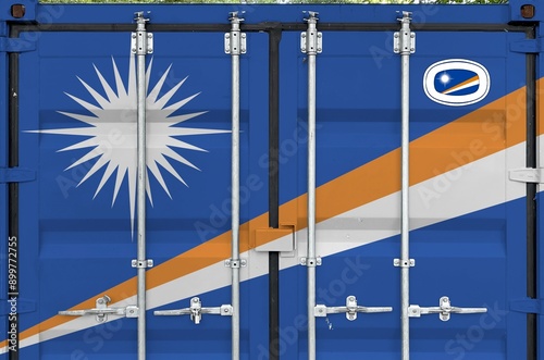 Marshall Islands flag depicted on metal doors of shipping cargo container outdoors in docks area close up photo