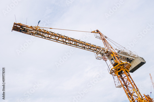 Tower Crane At Construction Site Outdoor. City Urban Development An Crane Do Lifting To Built To Infrastructure.