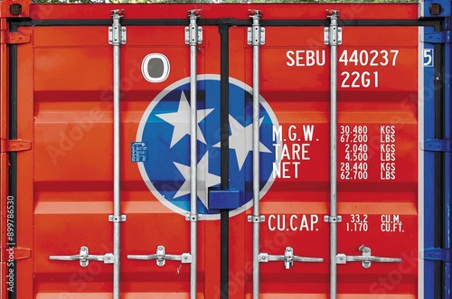 Tennessee US state flag depicted on metal doors of shipping cargo container outdoors in docks area close up photo