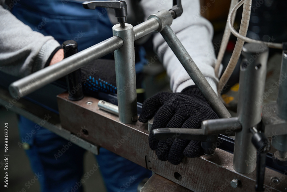 Worker fixed a part on a special machine