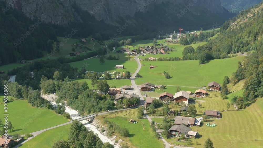 Aerial drone descending into Lauterbrunnen village in Switzerland. Aerial drone descending into Lauterbrunnen village in Switzerland.