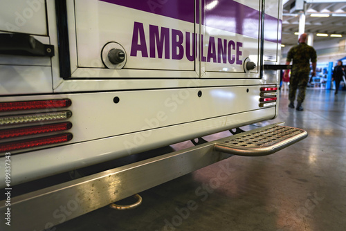 Ambulance van, detail on back door near ground, blurred people in background photo