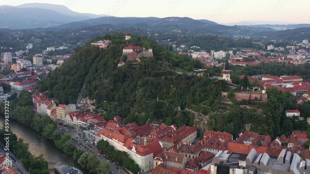 Graz Cityscape in Austria. Graz is the capital city of the southern Austrian province of Styria. At its heart is Hauptplatz, the medieval old town’s main square. Beautiful Sunset Light. Drone, 4k. Graz Cityscape in Austria. Graz is the capital city of the southern Austrian province of Styria. At its heart is Hauptplatz, the medieval old town’s main square. Beautiful Sunset Light. Drone, 4k.