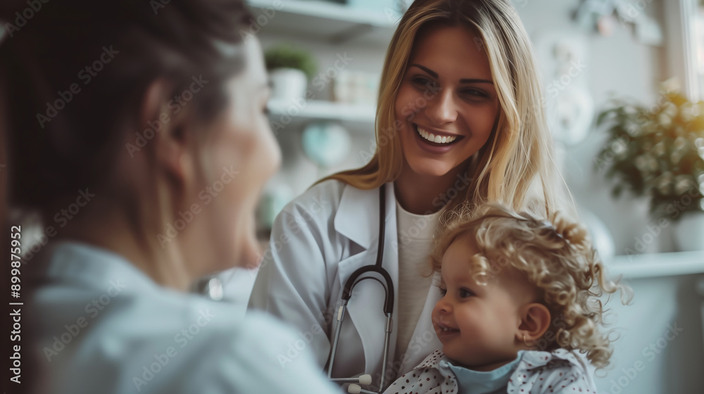 A smiling child and mother at the female pediatrician appointment in a medical office A smiling child and mother at the female pediatrician appointment in a medical office