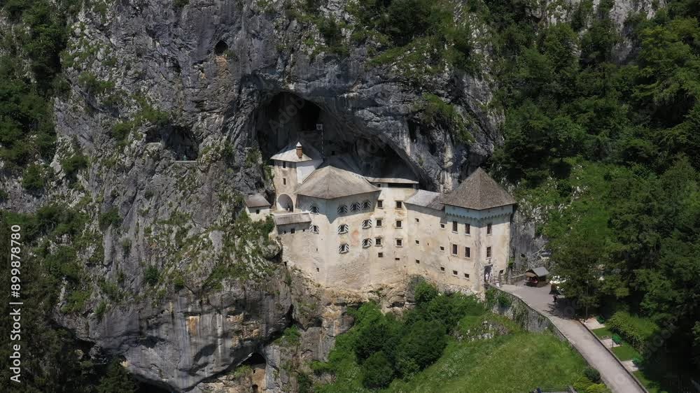 Predjama Castle in Slovenia, Europe. Renaissance castle built within a cave mouth in south central Slovenia, in the historical region of Inner Carniola. It is located in the village of Predjama. Drone Predjama Castle in Slovenia, Europe. Renaissance castle built within a cave mouth in south central Slovenia, in the historical region of Inner Carniola. It is located in the village of Predjama. Drone