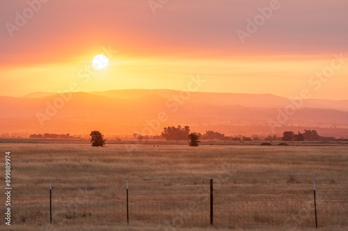 Smoke from wildfires colors sunrise over Sierra Nevada mountains near Palermo, California