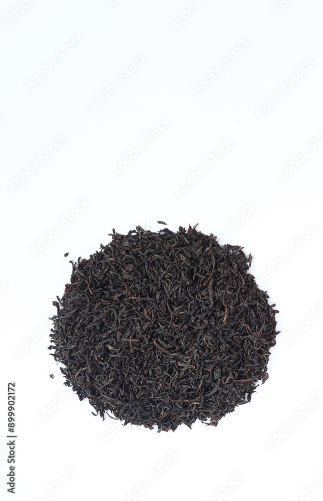 Black long tea on a white background. Top view of dried tea leaves. Tea composition. Ingredients for a hot drink, close-up. Background. Presentation of the type and variety of tea Black long tea on a white background. Top view of dried tea leaves. Tea composition. Ingredients for a hot drink, close-up. Background. Presentation of the type and variety of tea